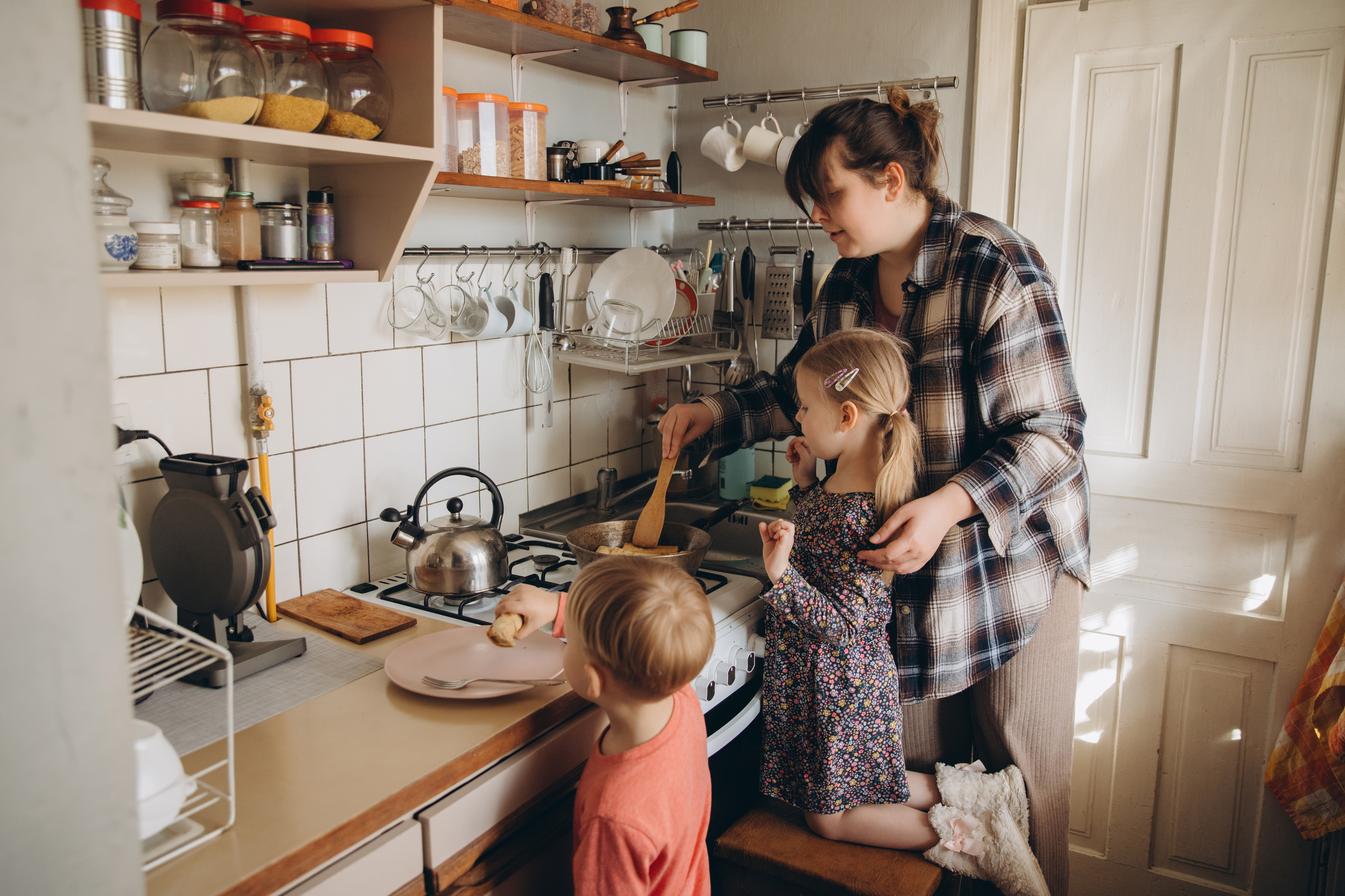 Mother preparing food with children