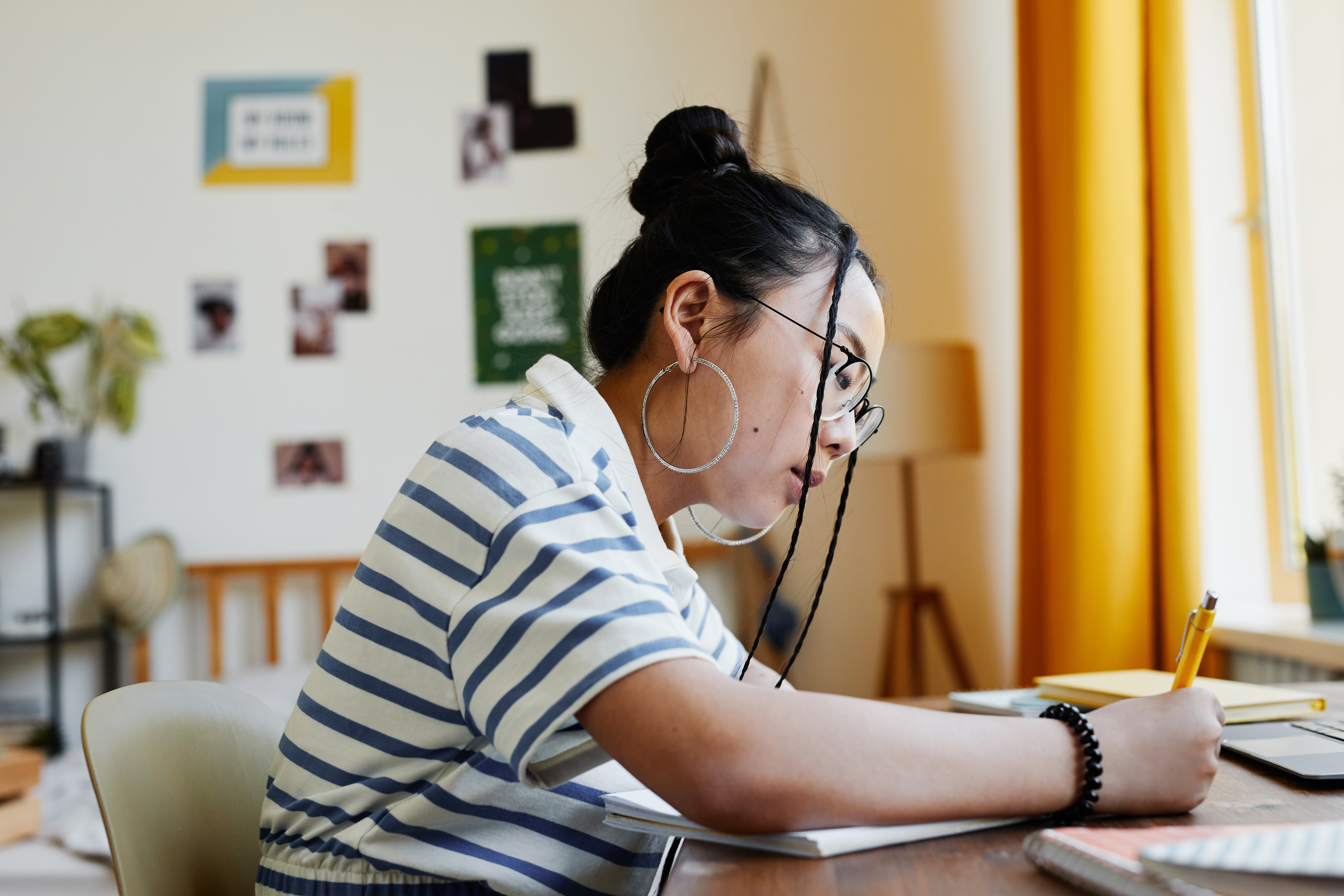 girl doing homework on desk
