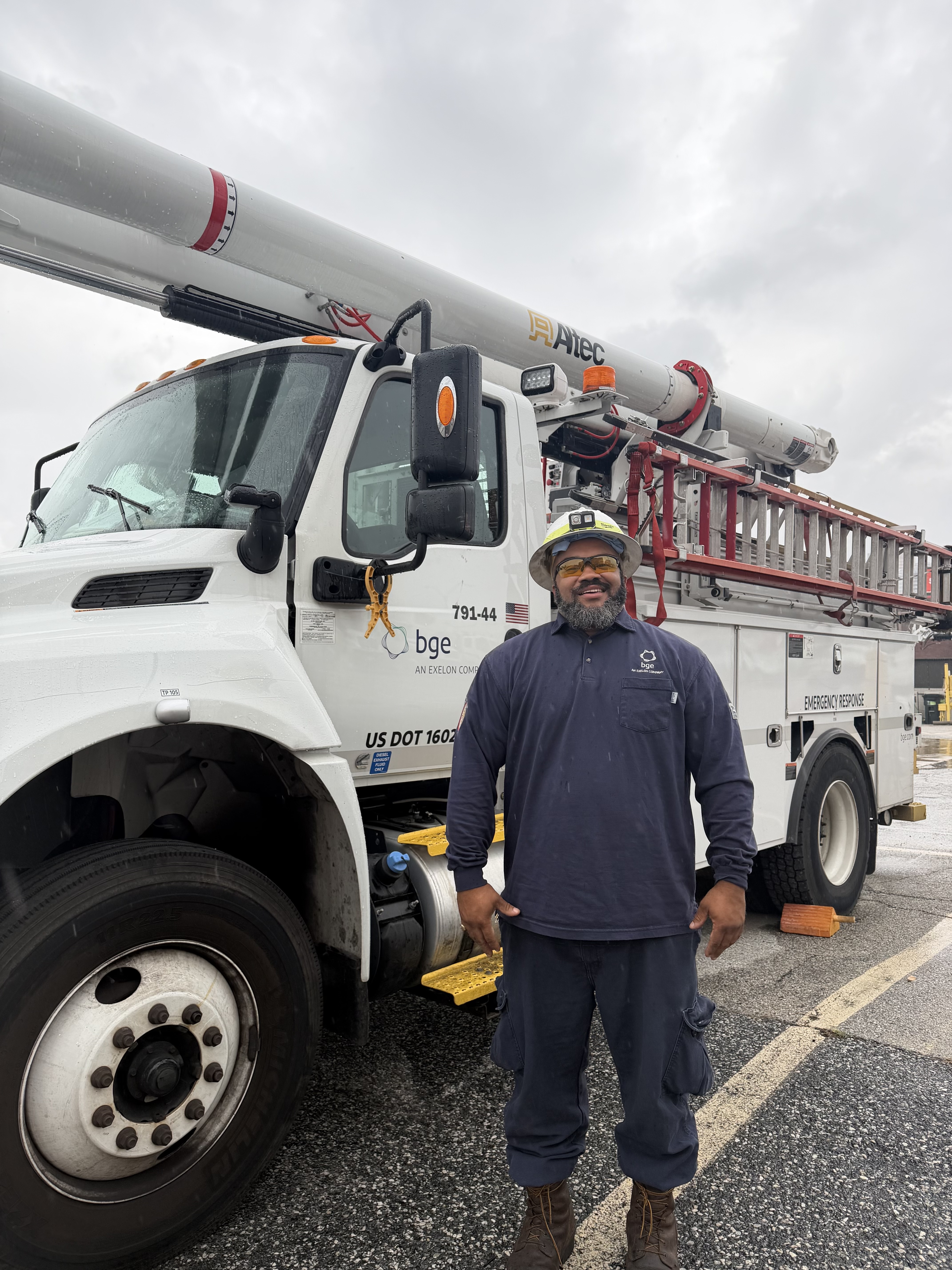 James Epps standing beside a BGE utility truck. 
