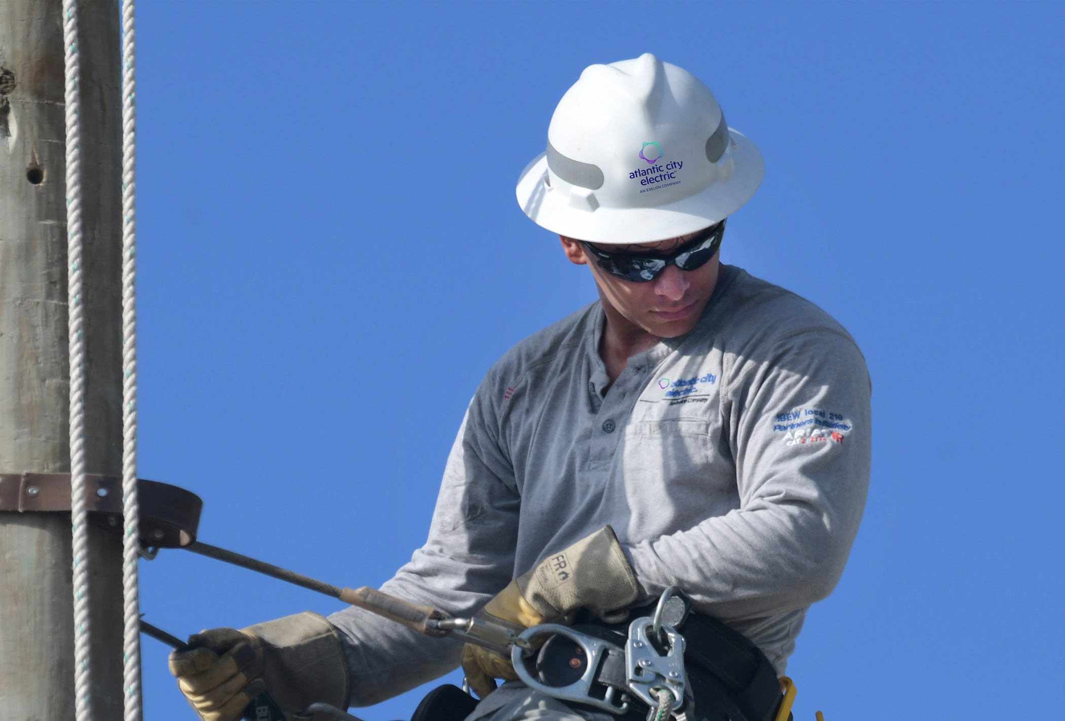 lineworker climbing utility pole