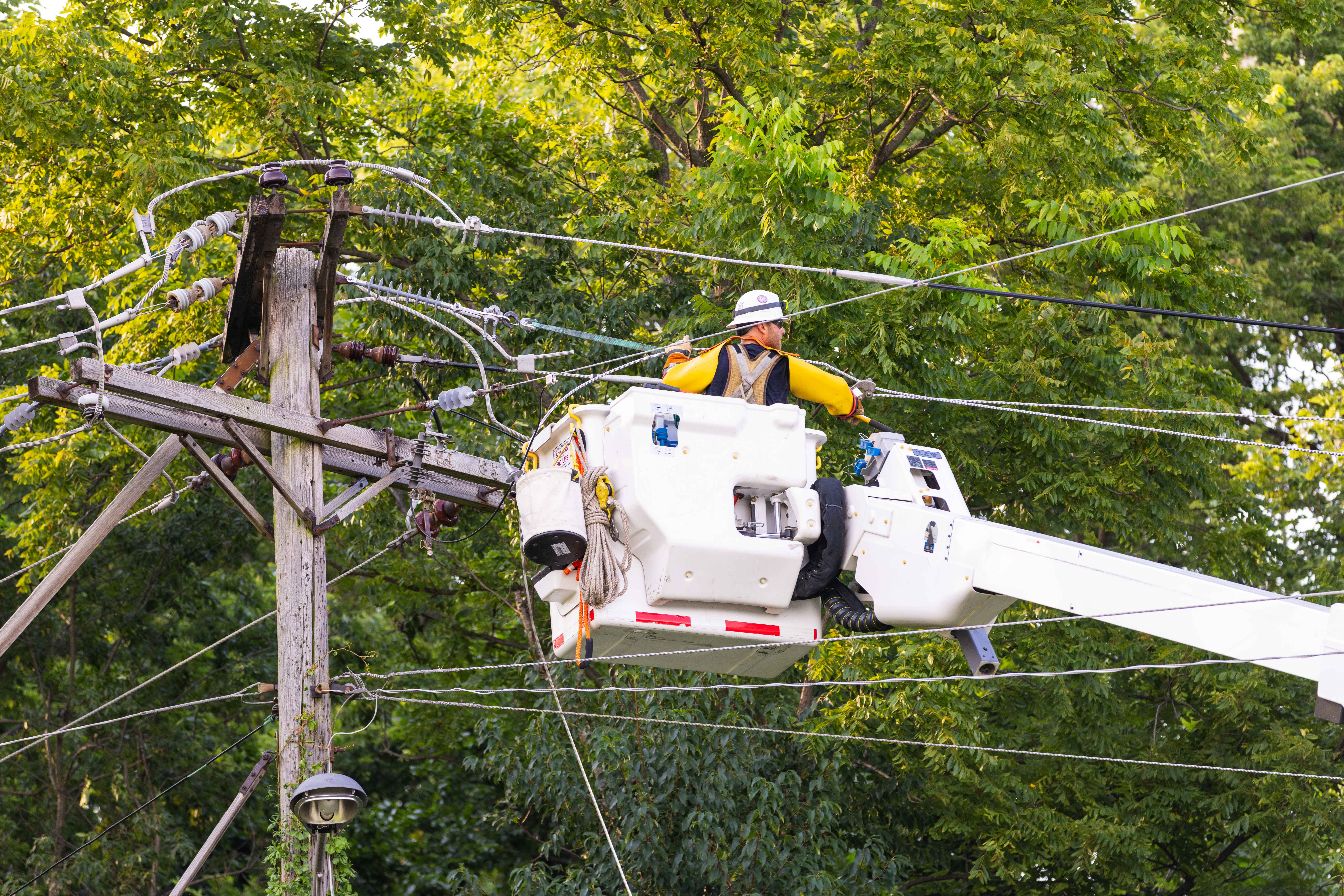 Utility working on a utility bucket truck