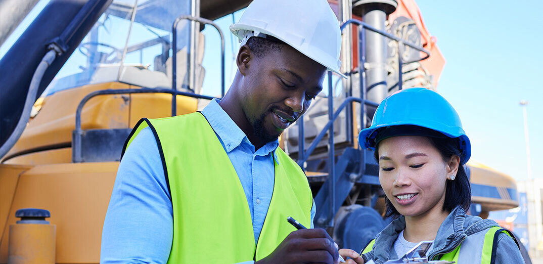 Two people reviewing work plans